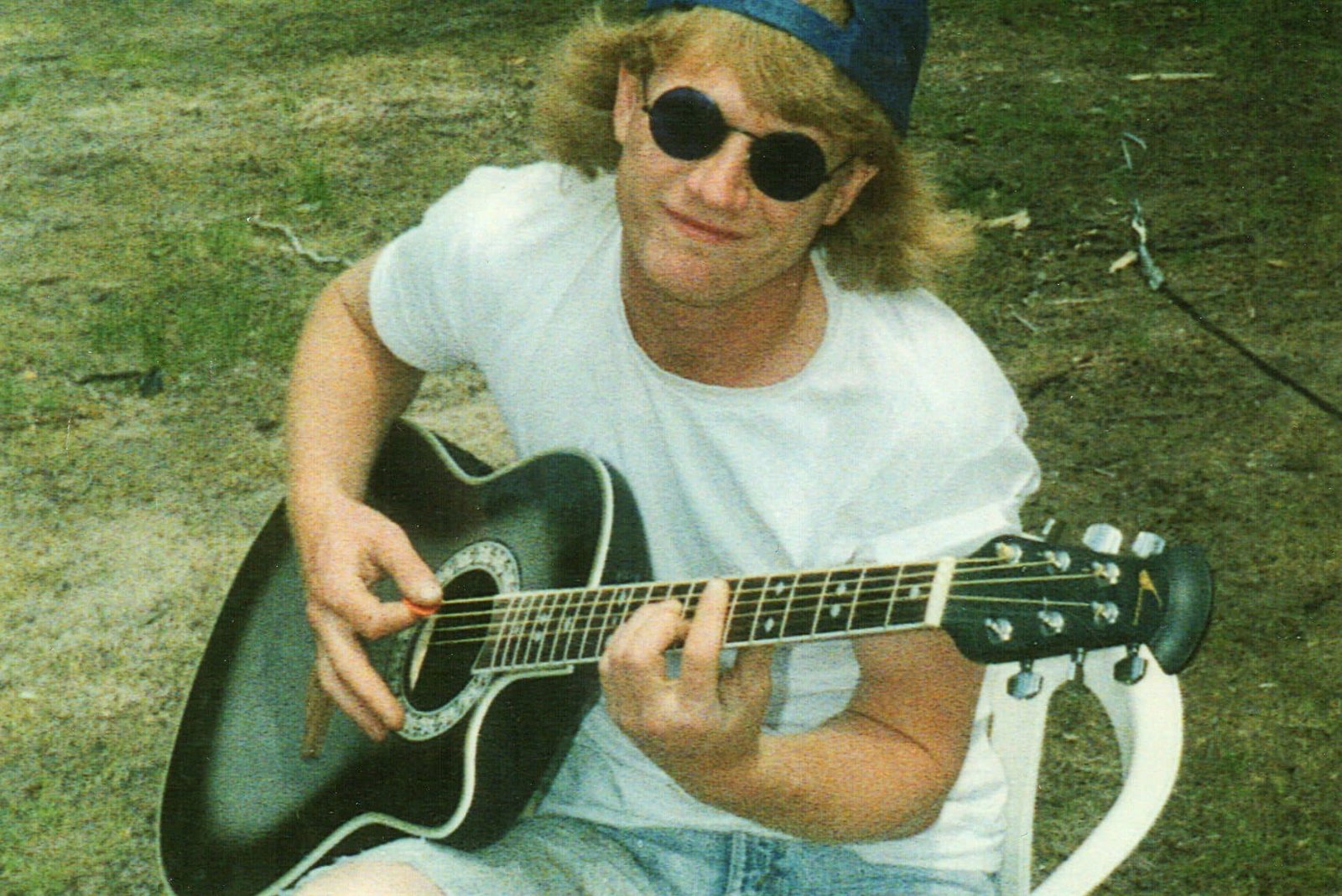 Circa 1994, Darrick plays guitar at the campsite, a glimpse of a passion for music that runs deep and lasts a lifetime.