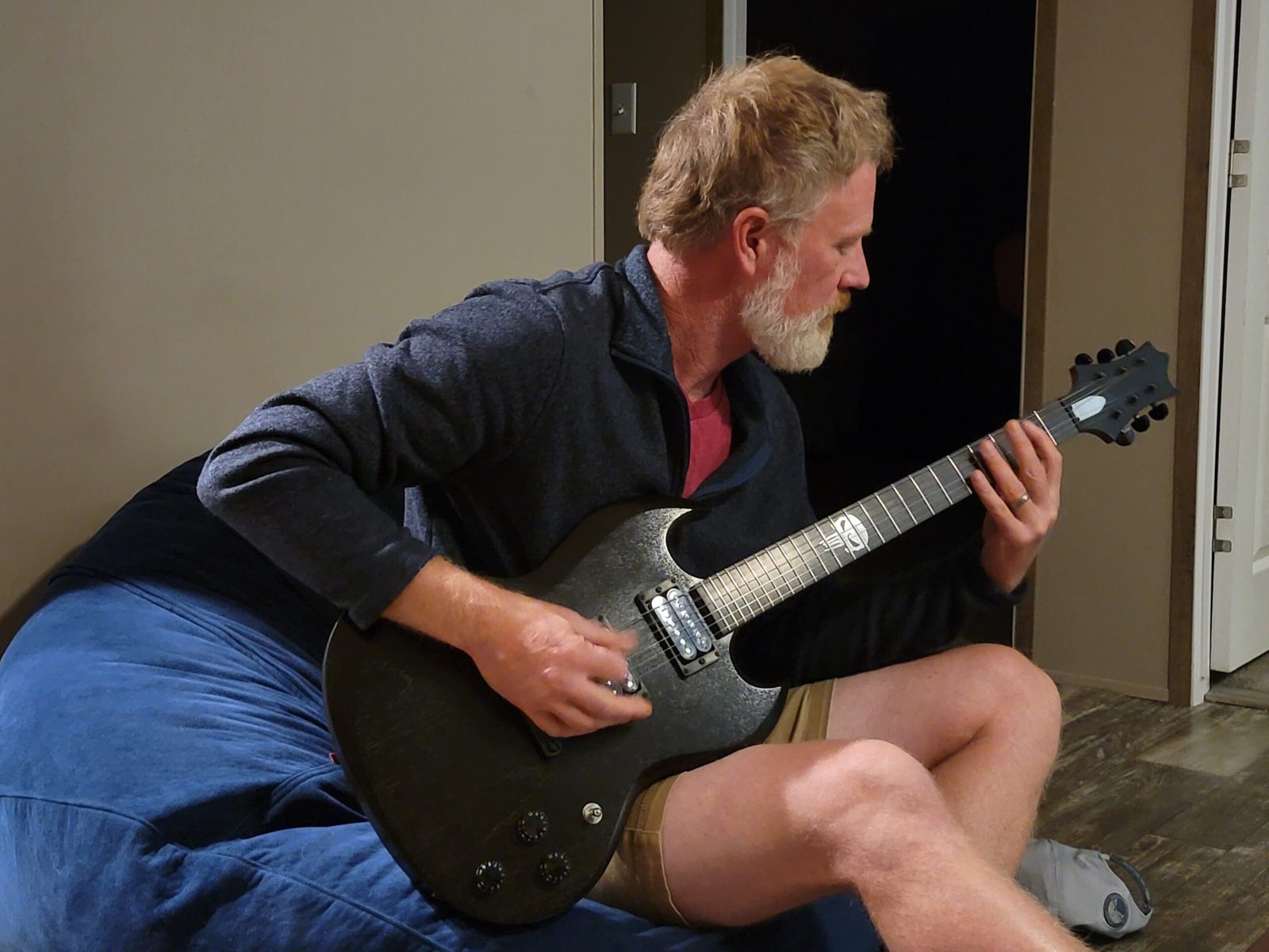 Darrick, our builder, plays the ESG guitar with his family one evening, sharing the music and craftsmanship behind Ellehsem Guitars.
