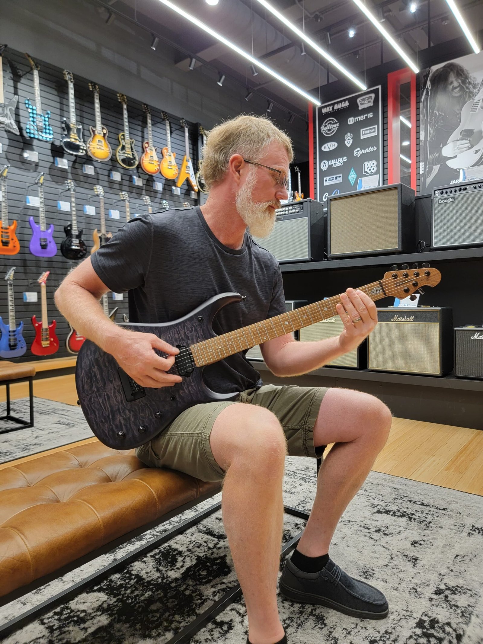 Darrick, the builder behind Ellehsem Custom Guitars, enjoying the guitars at Sweetwater.