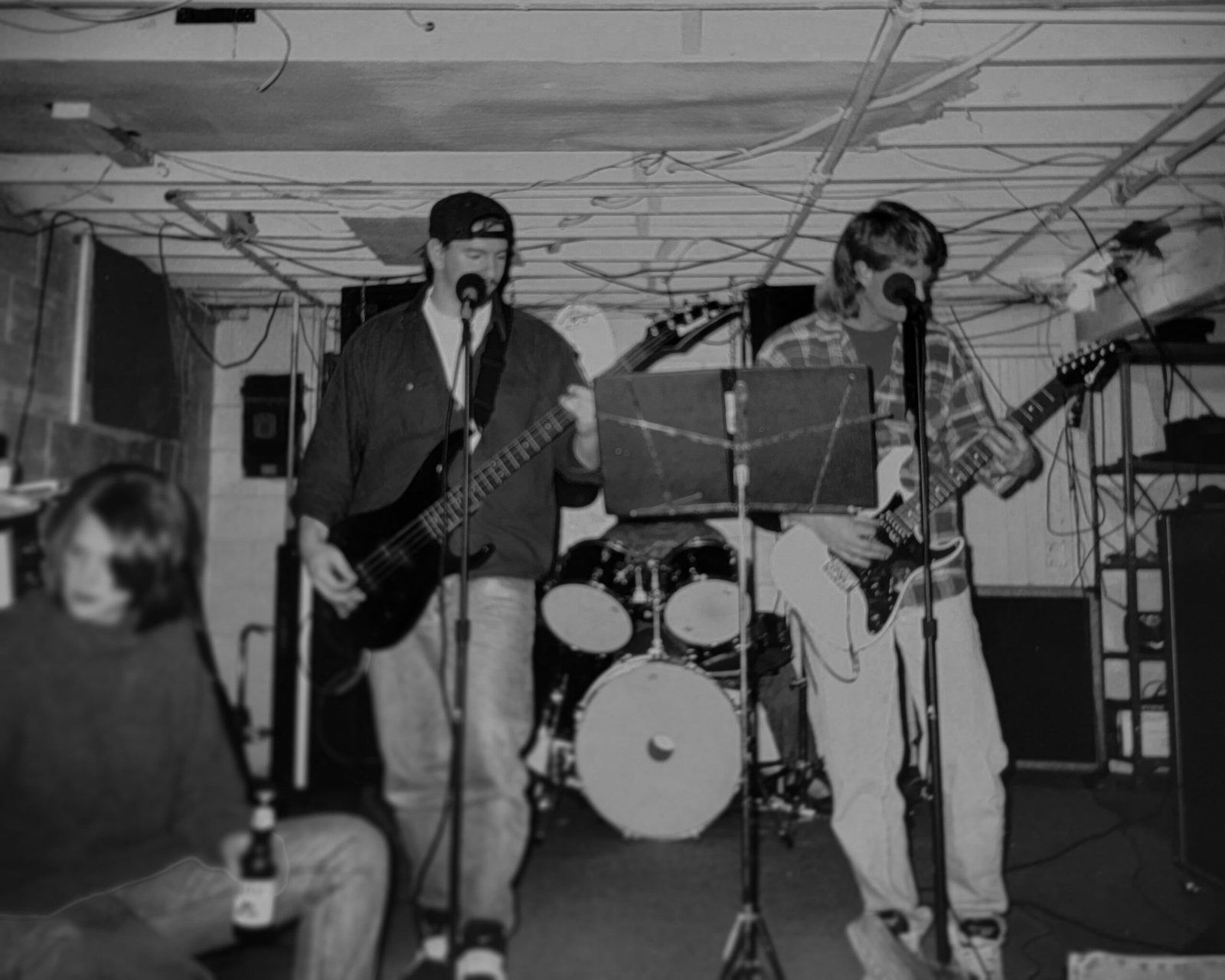 During the basement band days, Darrick plays guitar with his friends, capturing the early days of his passion for music and guitar building.