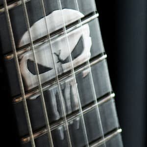 Aluminum Punisher inlay at the 12th fret of the ESG Punisher guitar, commissioned in 2021 and crafted as a distinctive detail of this one-of-a-kind instrument.
